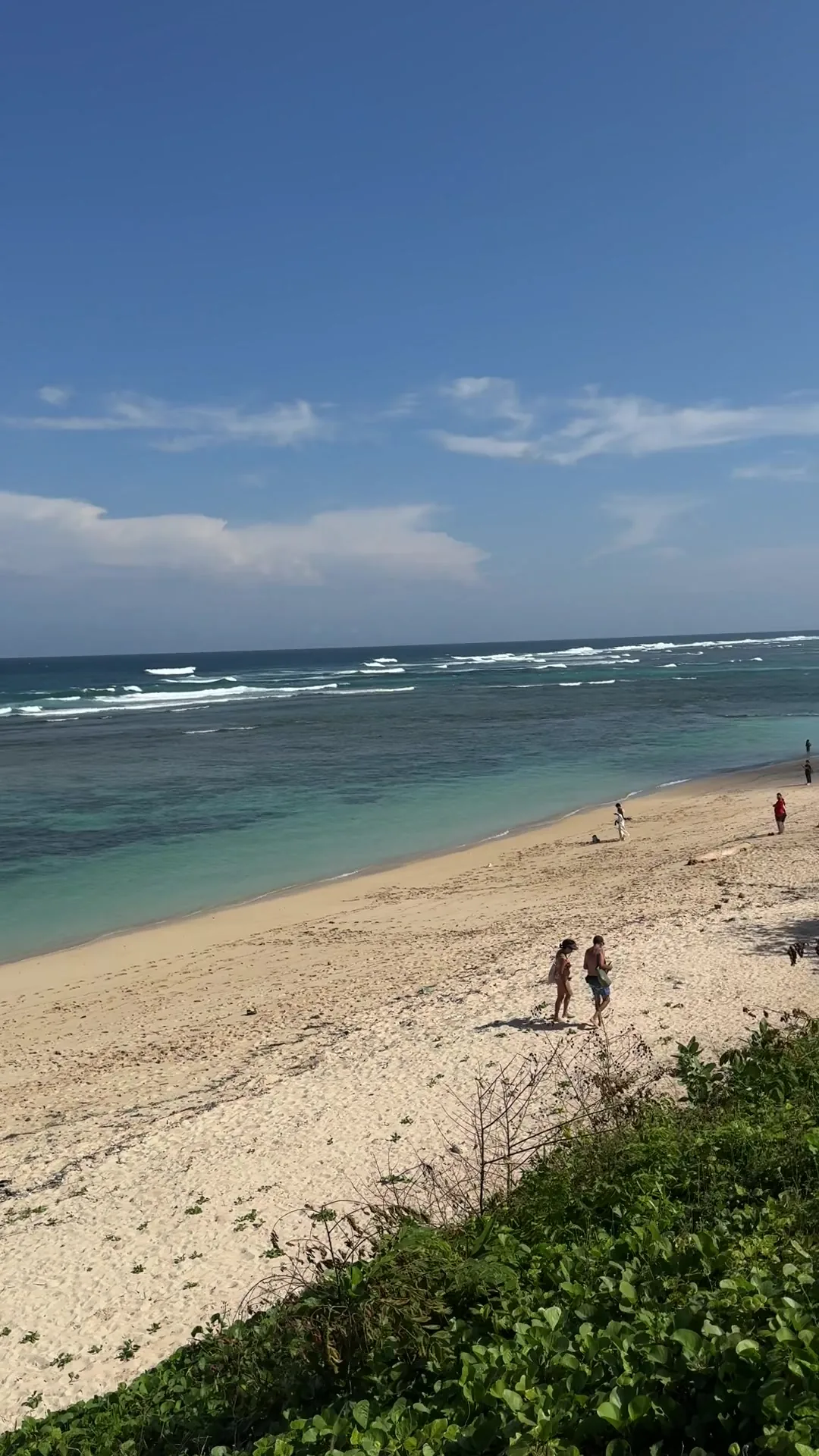 The sand at Pandawa Beach, waves breaking on the reef, taken from the path above.