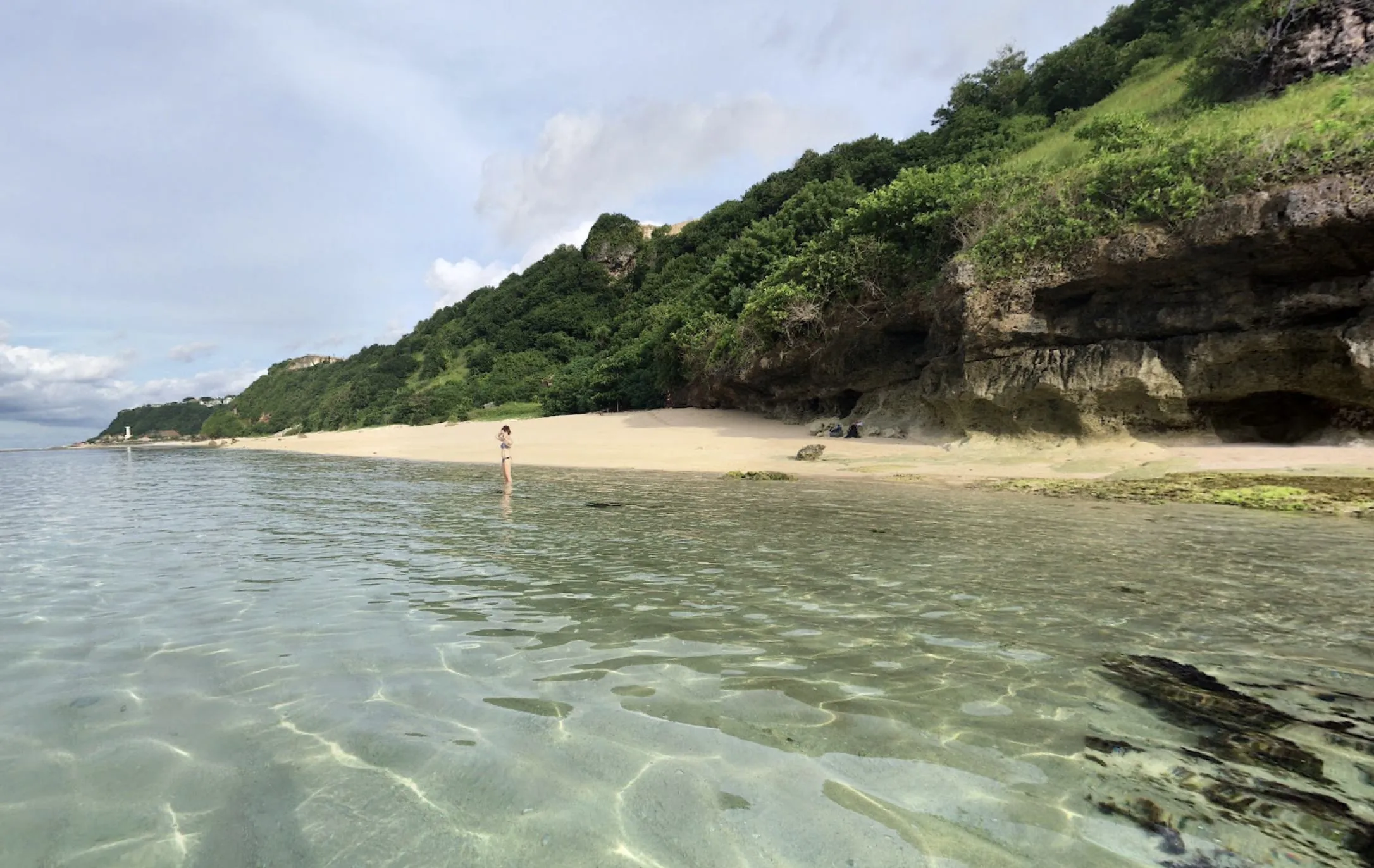 Clear shallow water below the cliffs.